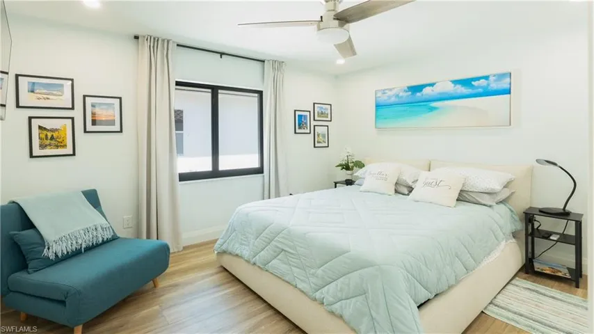 Bedroom with ceiling fan and light hardwood / wood-style floors