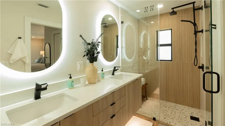 Bathroom featuring vanity and a shower with shower door