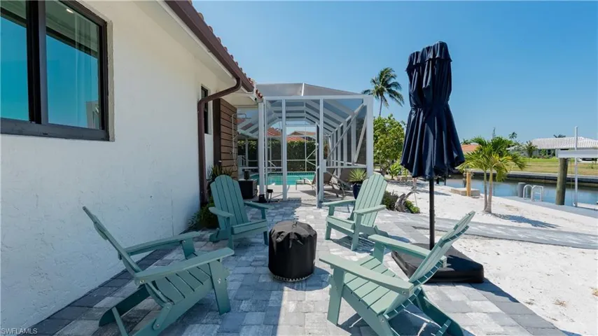 View of patio featuring glass enclosure