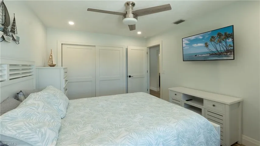 Bedroom featuring ceiling fan and a closet