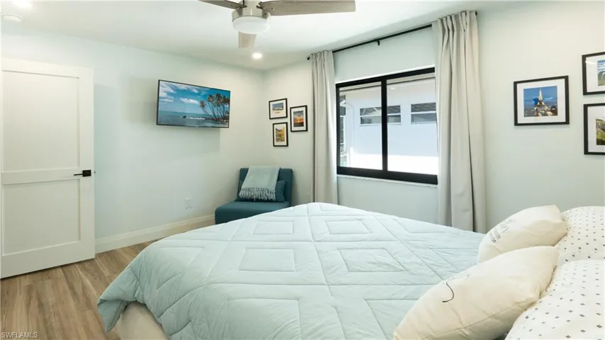 Bedroom with ceiling fan and light wood-type flooring
