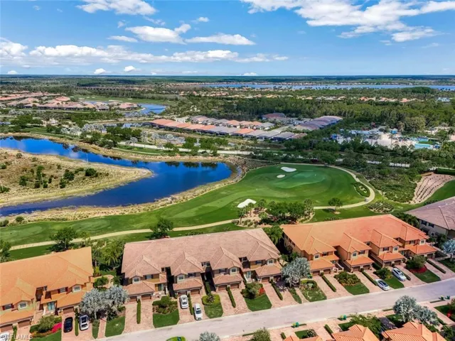 Ariel of condo building with golf course behind it.