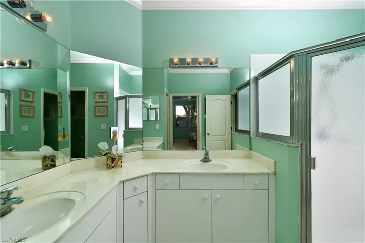 master bath with dual sinks and walk in shower