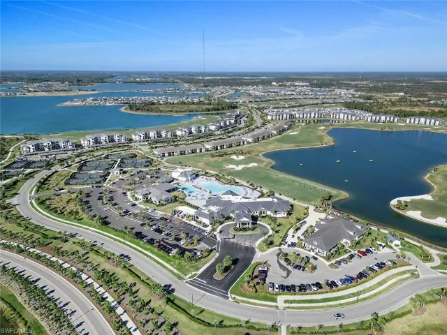 Expansive community featuring multiple lakes, a golf course, tennis courts, and several community buildings