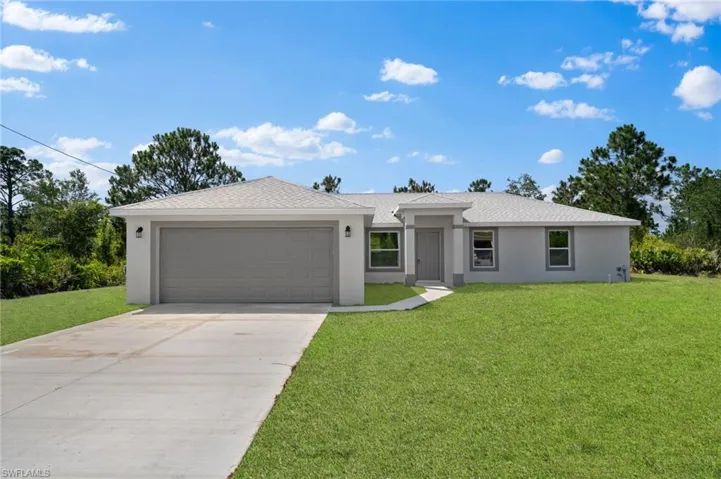 Ranch-style house with a front lawn and a garage