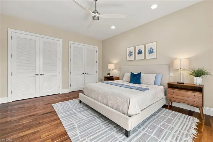 Room featuring wood-finish flooring, recessed lighting, a modern ceiling fan, and double-door closets with louvered detailing