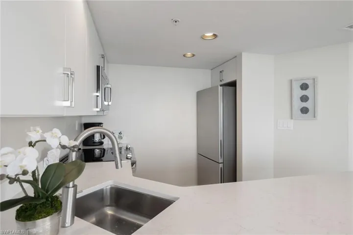 Kitchen with white cabinets, stainless steel appliances, and sink