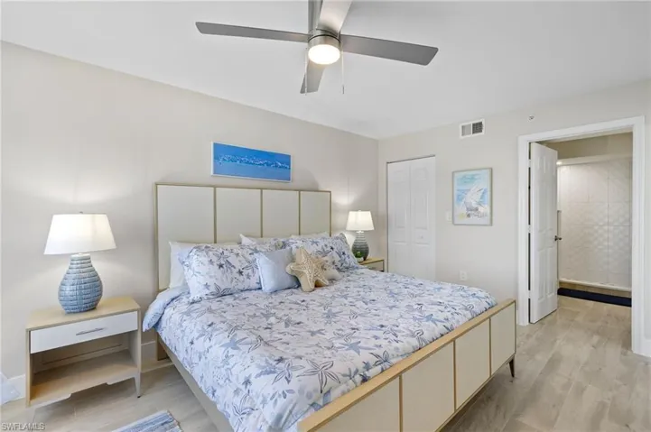 Bedroom featuring ceiling fan, light wood-type flooring, and a closet
