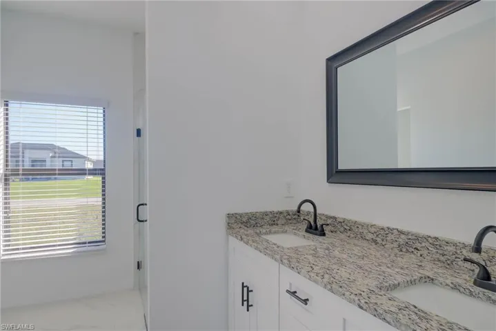 Bathroom featuring a healthy amount of sunlight and vanity