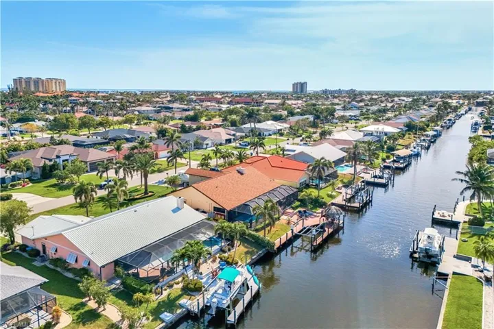 Awesome arial showing off the homes metal roof and huge dock and boat lift
