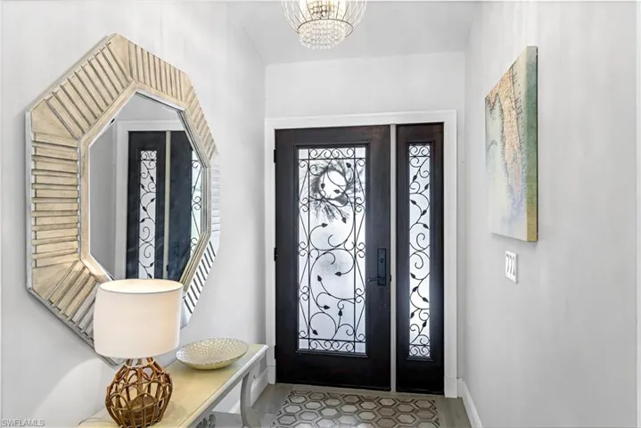showcasing the decorative front door welcoming in lots of light