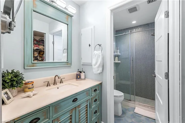 Primary bath with custom vanity and decorative custom tiled shower