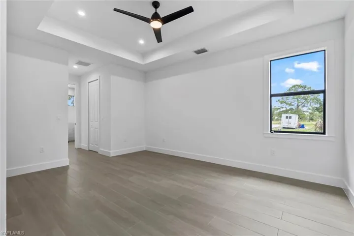 Master Room with a tray ceiling, and ceiling fan