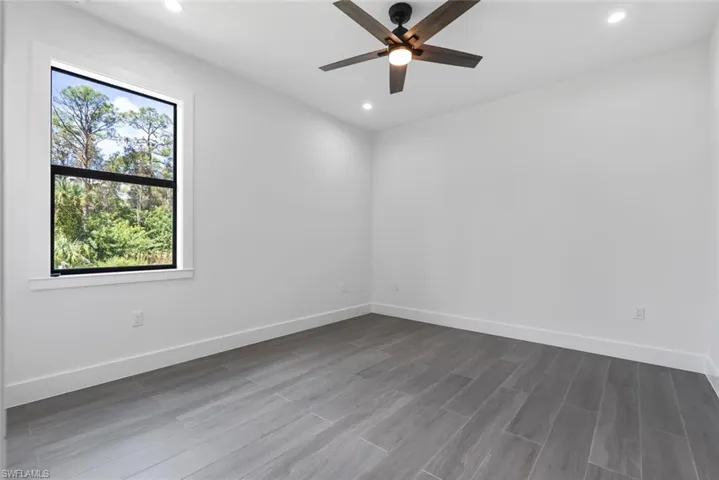 Unfurnished room with ceiling fan,  wood-style floors, and a healthy amount of sunlight