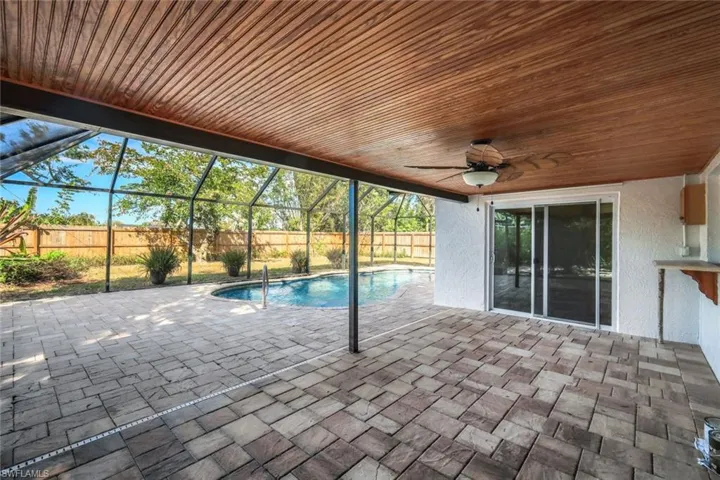 View of swimming pool featuring a fenced in pool, a patio, a fenced backyard, ceiling fan, and a lanai