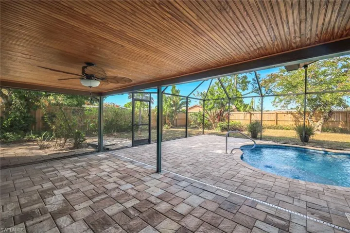 View of pool featuring a fenced in pool, a ceiling fan, a fenced backyard, a lanai, and a patio area