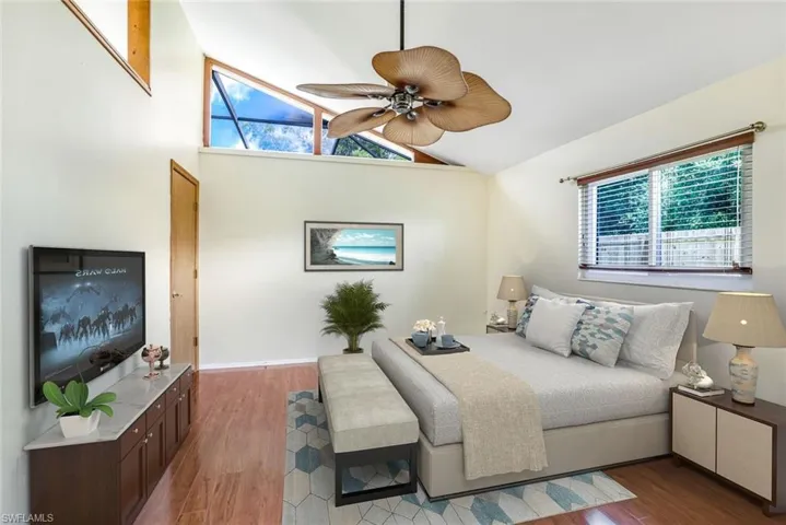 VIRTUAL STAGING Bedroom with ceiling fan, baseboards, vaulted ceiling, and wood finished floors