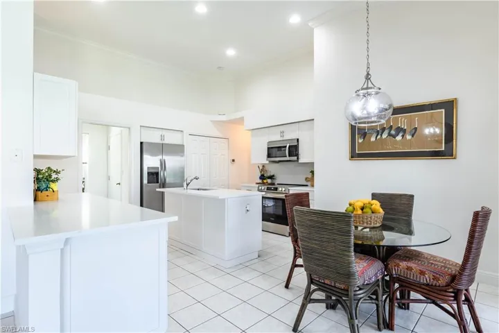 Kitchen featuring appliances with stainless steel finishes, crown molding, and white cabinets