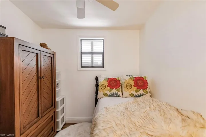 Bedroom with  ceiling fan and armoire