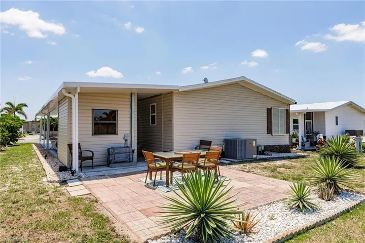 Back of house with a patio area and central AC