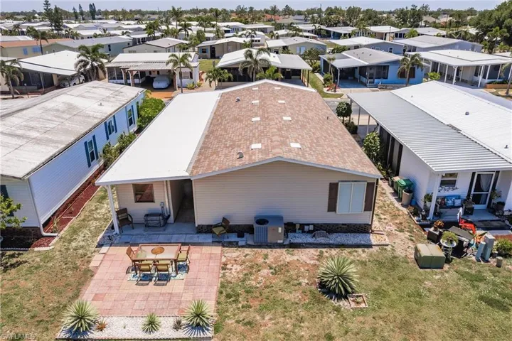 Back of property featuring a residential view, central AC unit, and a patio area