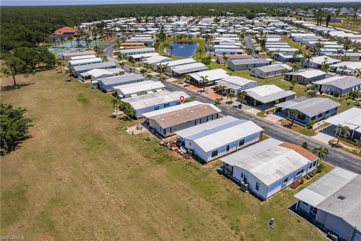 Drone / aerial view with a water view and a residential view