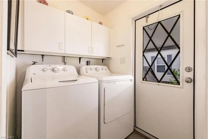 Laundry room with newer washer and dryer and cabinet space