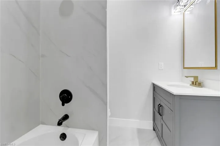 Bathroom with tub / shower combination and vanity