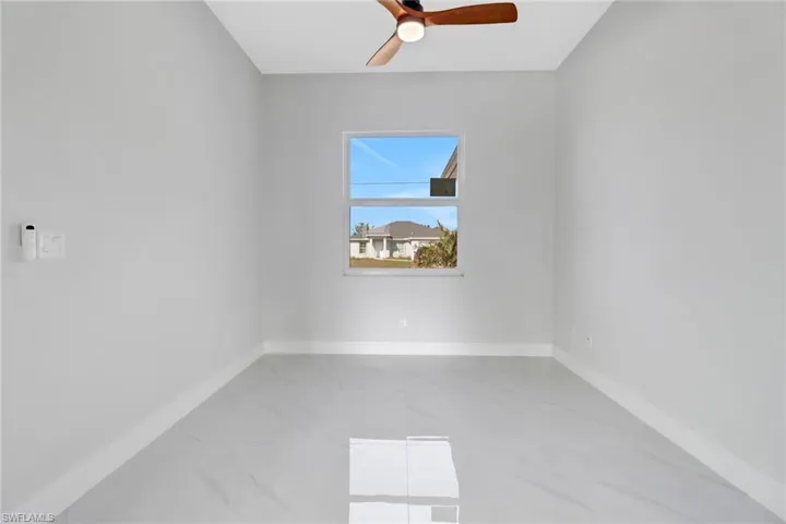 Empty room featuring ceiling fan
