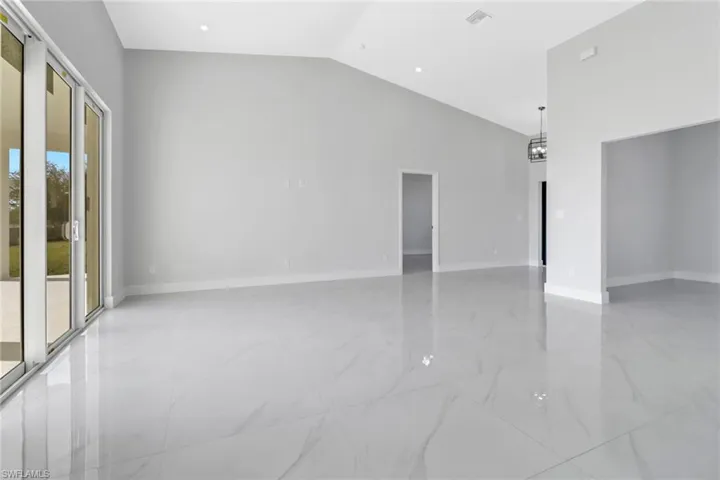 Spare room with lofted ceiling