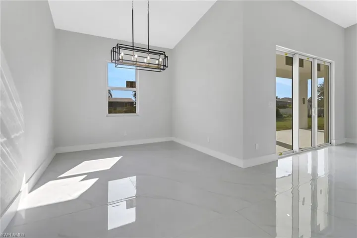 Unfurnished dining area with an inviting chandelier