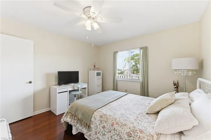 Bedroom with hardwood flooring and ceiling fan