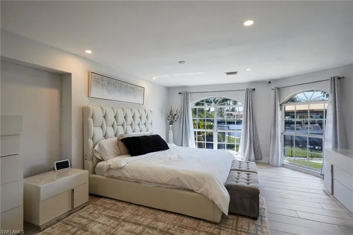 Bedroom with baseboards, recessed lighting, water views