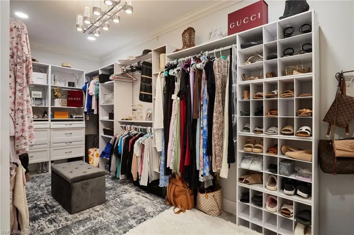 Walk in closet featuring an inviting chandelier