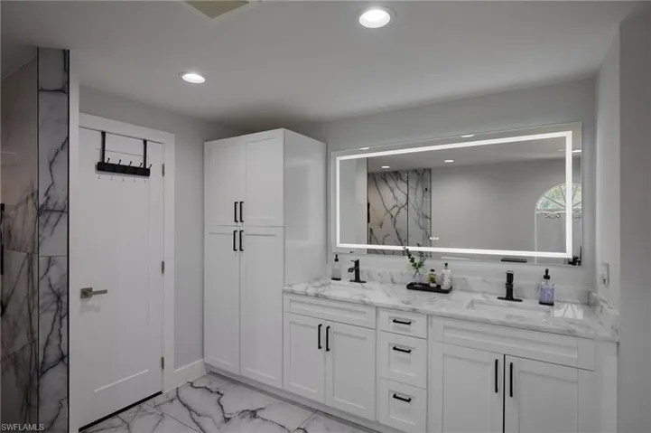 Full bath featuring double vanity, ample storage, and recessed lighting