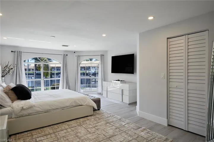 Bedroom with baseboards, recessed lighting, water views