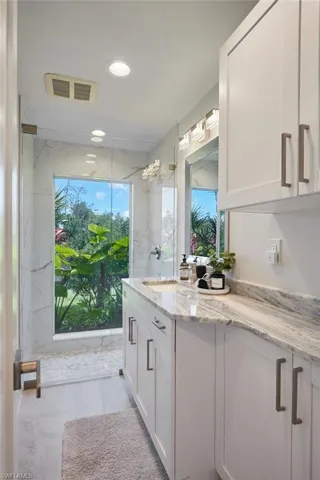 Full bathroom and vanity with beautiful natural lighting