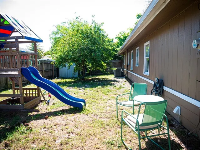 Large backyard featuring a playground