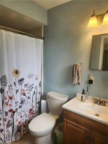Master bathroom with vanity and a shower with curtain