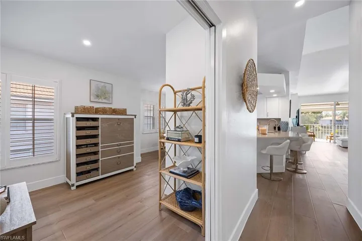 Hallway featuring light wood-style flooring and recessed lighting