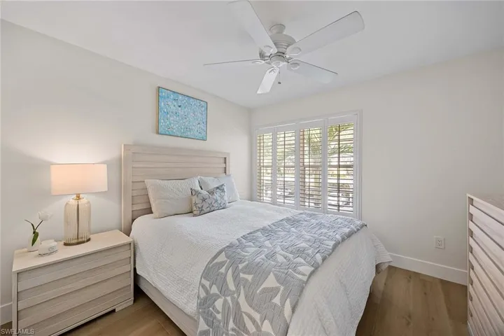 Bedroom featuring wood finished floors and a ceiling fan