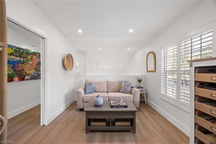 Living area featuring light wood-style flooring and recessed lighting