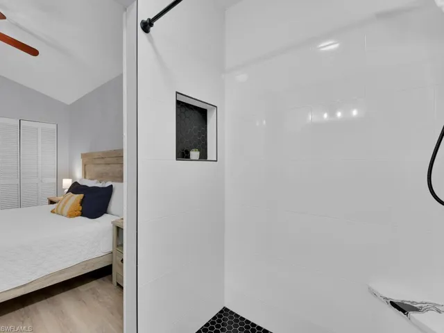 Principle bath walk in shower has a seat and wall niche.