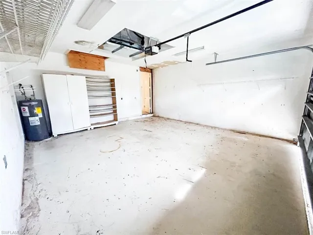 Garage with water heater and a garage door opener
