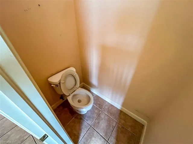 Bathroom with tile patterned floors and toilet