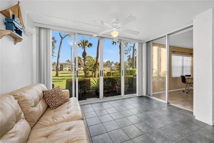 Sunroom / solarium featuring expansive windows and tile patterned flooring