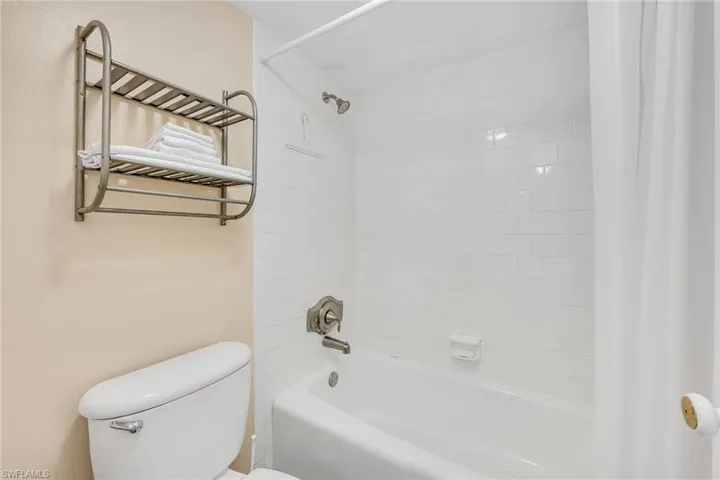 Bathroom featuring shower / bath combo with shower curtain and toilet