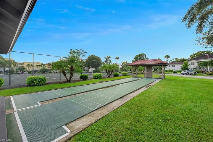 View of community with shuffleboard and a gazebo
