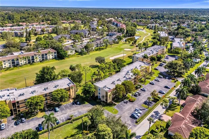 Aerial overview of property's location featuring a local golf course and a large body of water