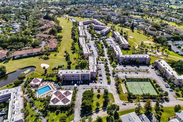 View of property location with a golf course and a large body of water